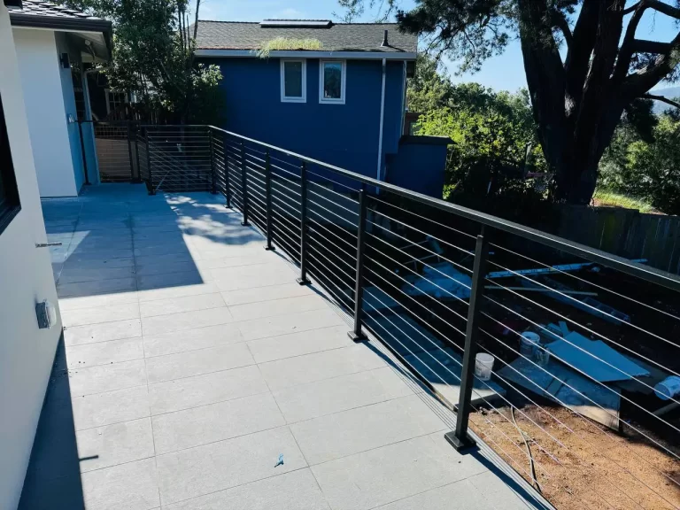 Custom cable railing system on a contemporary outdoor deck, crafted by Usairs, serving San Francisco, Oakland, and San Jose.